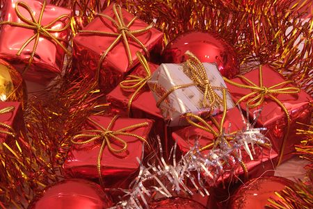 Christmas presents surrounded by seasonal ornaments with cute and powerful colors, along with Christmas tree balls.の写真素材