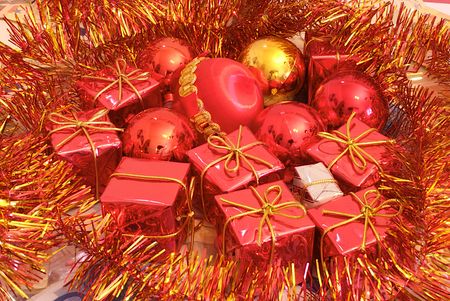 Christmas presents surrounded by seasonal ornaments with cute and powerful colors, along with Christmas tree balls.の写真素材
