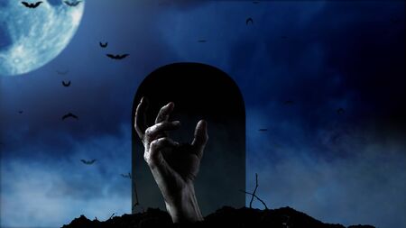 Spooky graveyard with zombie hand coming out of the groundの写真素材