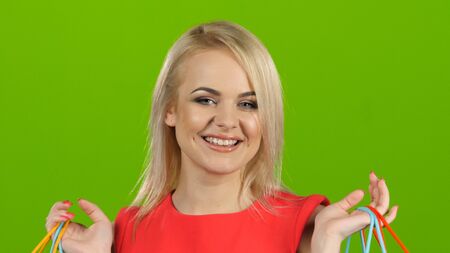 Happy shopping woman excited and cheerful. Green screen studio. Close upの写真素材