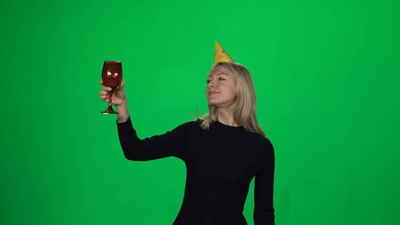 Woman having fun on birthday party. Green screenの写真素材