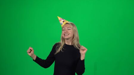 Lady in a birthday hat. Green screenの写真素材