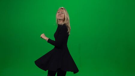 Woman dancing and singing in black dress. Green screenの写真素材