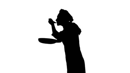 Black silhouette of chef in a hat is frying and tastes the dish. Isolated on white background.の写真素材