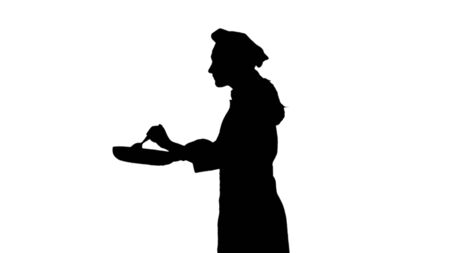 Black silhouette of chef in a hat is frying and tastes the dish. Isolated on white background.の写真素材