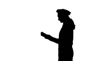 Black silhouette of chef lady with long hair reading cookbook.の写真素材