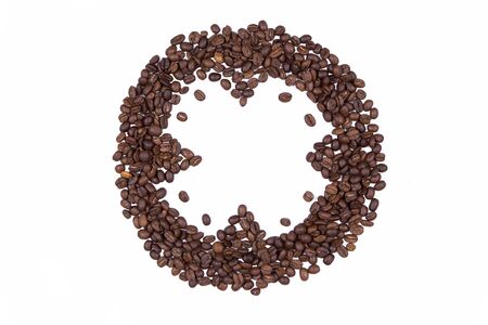 Coffee beans gathered are laid out in a circle isolated on white background top viewの写真素材