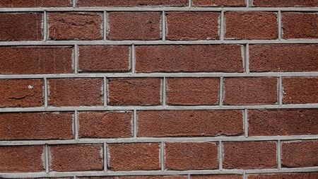 Abstract brick wall background. Red brick wall texture. An brick wall showing close up detailの写真素材