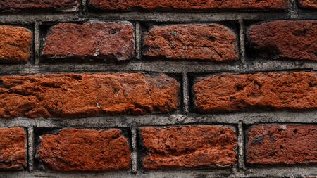 Abstract brick wall background. Red brick wall texture. An old brick wall showing close up detailの写真素材