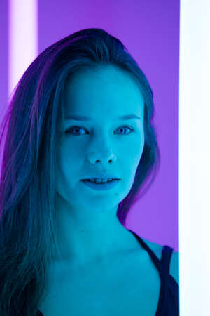 Studio portrait of a sexy young woman with beautiful face and long hair in the studio with amazing...