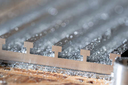 Metal detail in shiny steel shavings close up. Machining of metallic product for mechanical...