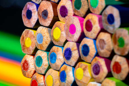 Background of colorful colored pencils. Multicolored wooden pencils close up. Stationery set for...
