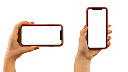 Set of a female hands with red nails holding red smartphone with a white screen on a white isolated...