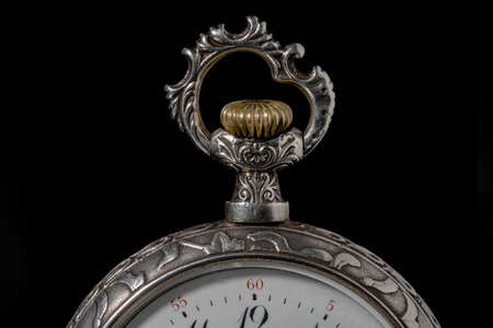 Part of a silver antique watch with a carved eyelet for chain and a gold winding mechanism on a...