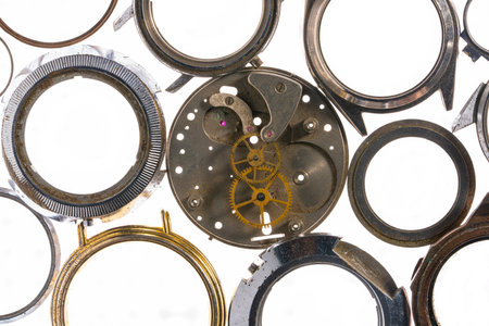 Top view of round silver cases from wristwatches and clockwork with gears. Empty metal dials from...