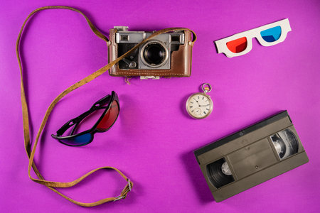 Silver vintage pocket watch and 3D glasses with blue red stereoscopic lenses. Black plastic VHS...