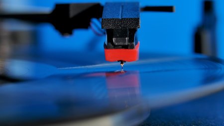 Vinyl record disc spinning on the classic gramophone player against colorful background. Vinil...