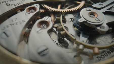 Internal vintage clockwork mechanism macro. Gold gears, metal gearing, wheels with tootheds....