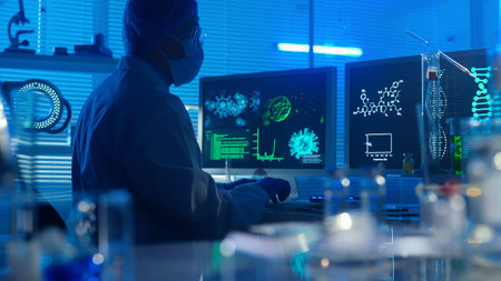 Dark silhouette of a man in white gown types on a computer keyboard. A male researcher against the...