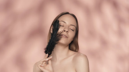 Facial skin care. Attractive young woman demonstrates smooth and soft skin by touching her face with...