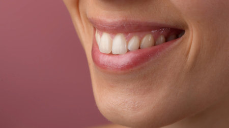 Zoom shot of caucasian woman part of the face without makeup, natural view. Closeup of female pink lips, smiling with white teeth and gums.の写真素材