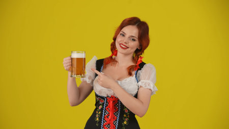 Medium yellow background isolated shot of a young German woman, waitress, wearing a traditional...