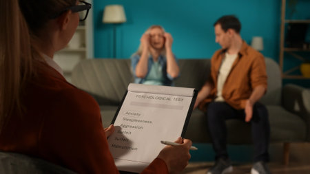 A psychotherapist administers a psychological test to the couple, taking notes. A clipboard with a...