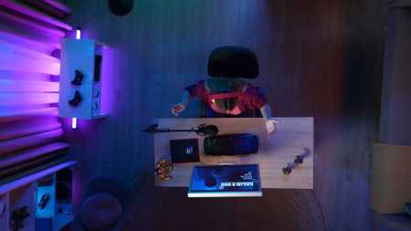 Top view of woman at the computer in headphones, failed the mission in the online video game, sad expression.の写真素材