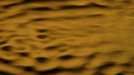 Beautiful golden light water surface with circles and waves, abstract background, wallpaper template.の写真素材