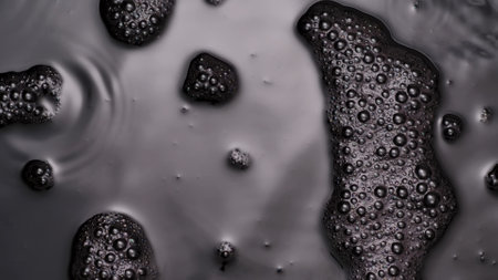 Monochrome light colored water surface with soap bubbles, abstract background wallpaper template.の写真素材