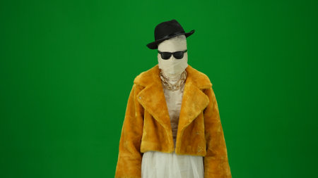 Glamorous mummy in an orange fur coat, hat and sunglasses. Green screen isolated chroma key. Mock up, workspace, advertisement. Medium size.の写真素材