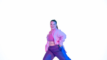 Attractive woman dancing jazz-funk on white isolated background in a studio. Blue and pink...