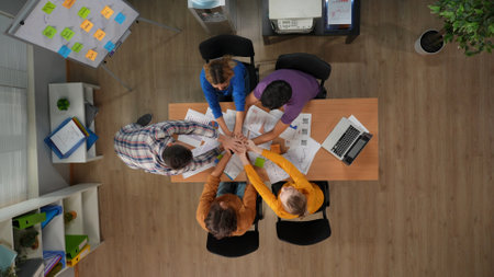 Top view of office boardroom with young men and women workers. Teambuilding coworkers and boss...