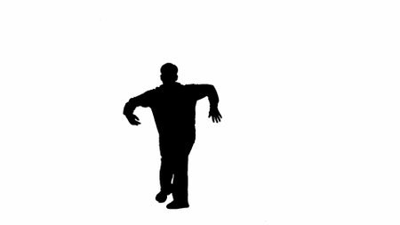 Framed against a white background in silhouette shot. A male dancer is depicted, only his outline is visible. Demonstrates a dance movement, poses with his arms apart. He is plastic, rhythmicの写真素材