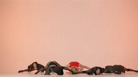 Framed against a pink background. Collective of young women in revealing clothing. Demonstrate a dance number, movement in the direction of high heels, stretching. They are beautiful, slender.の写真素材