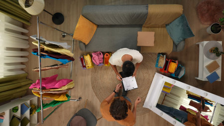 Top view of modern apartment living room. Delivery man comes and brings mail box with order, man...