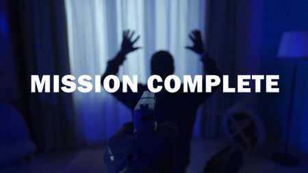 The inscription mission completed in the game against the background of a robber with his hands raised. A first person multiplayer game for smartphones and computers.の写真素材