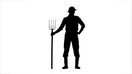 Portrait of farmer isolated on white background with alpha channel. Silhouette of person gardener standing with pitchfork holding hands on waist.の写真素材