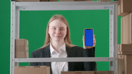 In a frame on a green background of chromakey. There is a young woman in a suit. The manager is...
