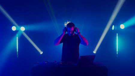 Professional DJ Mixing Music at Nightclub Eventの写真素材