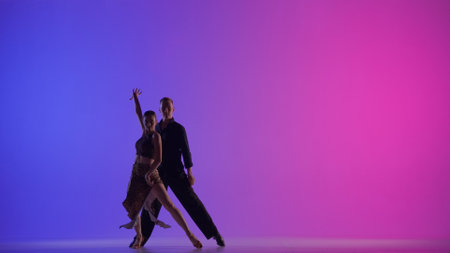 Elegant Ballroom Dance Couple on a neon backgroundの写真素材