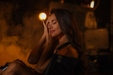 Portrait of Beautiful woman actress. Brunette model with makeup in lingerie sitting on directors...
