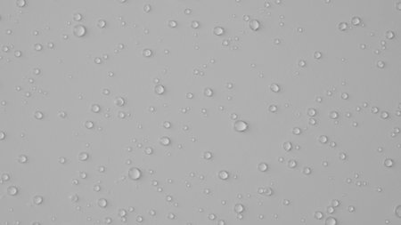 Lots of shiny water droplets on glass on white background of studio. Water splashes of rain. Aqua particle creative advertising concept.の写真素材
