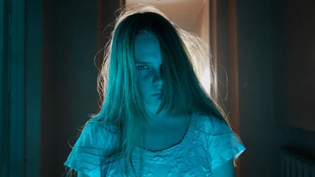 Portrait of ghost female in the house. Woman in white dress with scary face expression looking...