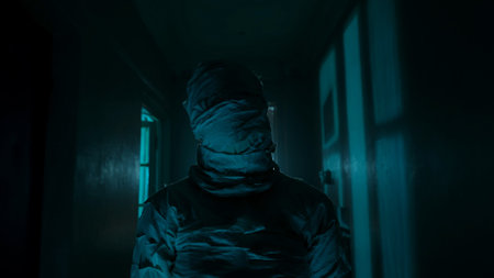 Portrait of ghost person in the house. Mummy covered in white cloth ribbons walking in the corridor...