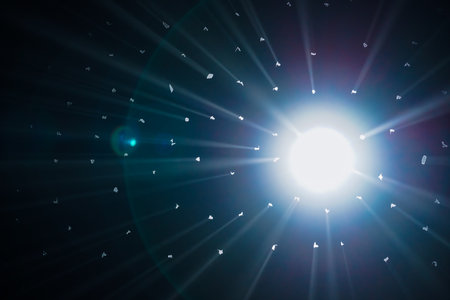 Rays of bright light come through holes in the black background of the studio. The rays cut through...