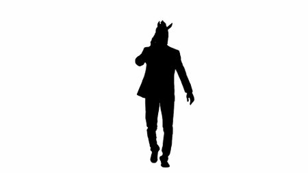 Black silhouette of man in business suit with horse head mask on white isolated studio background. Businessman walking and talking on smartphone. Concept of hard office work.の写真素材