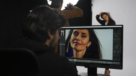 Backstage of model and professional team in the studio. Close up of model in suit posing,...