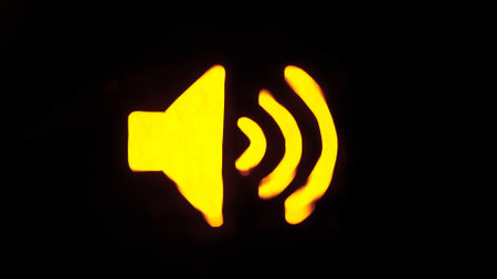 Symbols in waves concept advertising. Sign template isolated on black background. Neon yellow glowing speaker symbol.の写真素材