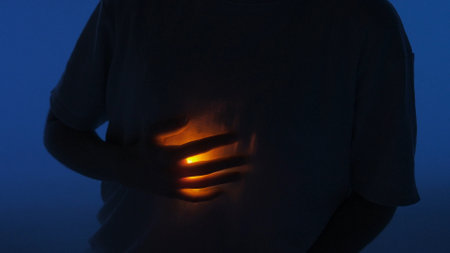 Female dancer performing in the studio. Young woman in dark studio touching warm light glowing...